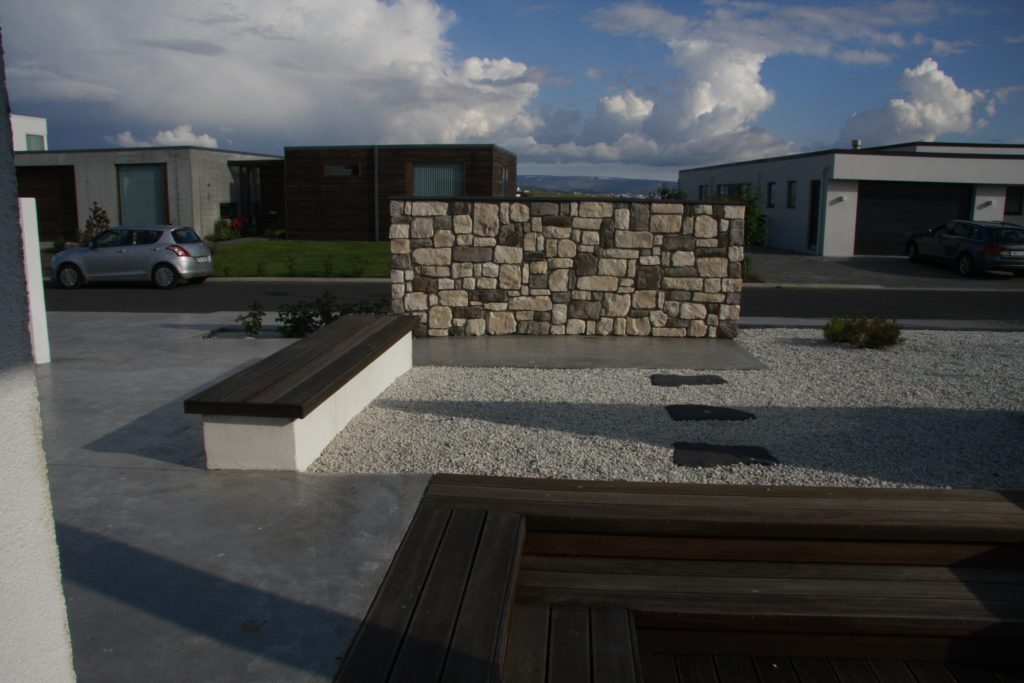 Minimalist bench and stone wall with Japanese style gravel 