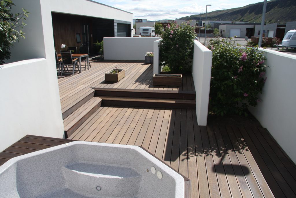 Functional house and decking surrounded by white walls