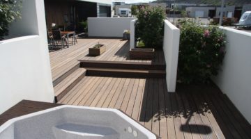 Functional house and decking surrounded by white walls