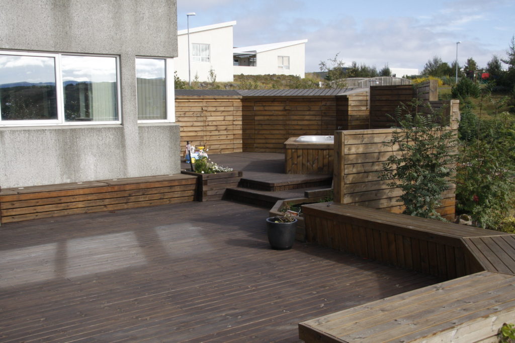 Sheltering walls, a storage unit and a large deck for outdoor living